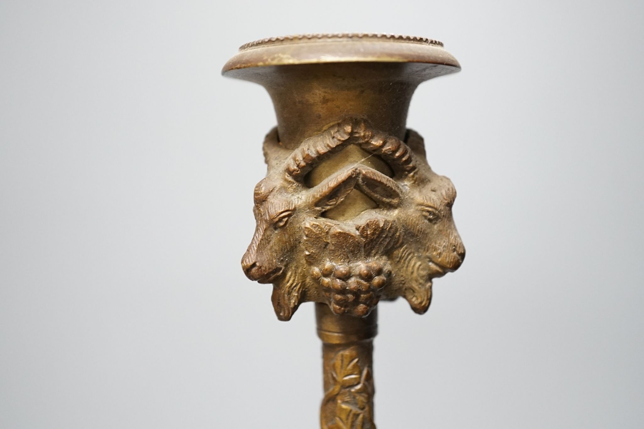 A 19th century bronze desk stand and a similar ‘rams head’ and ‘lion’ candlestick, height 33cm